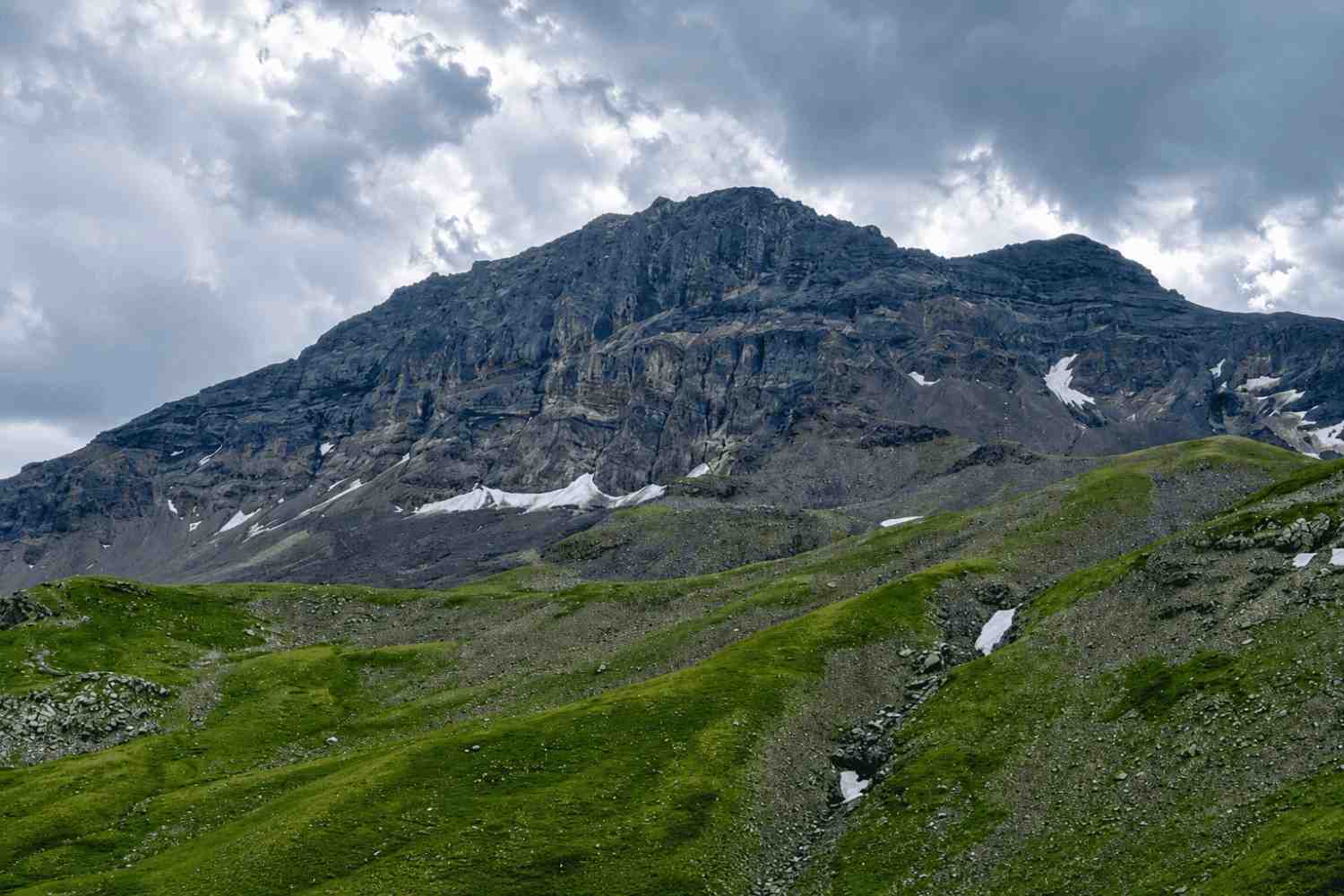 A small figure in the open mountain landscape beyond Rapi Lake